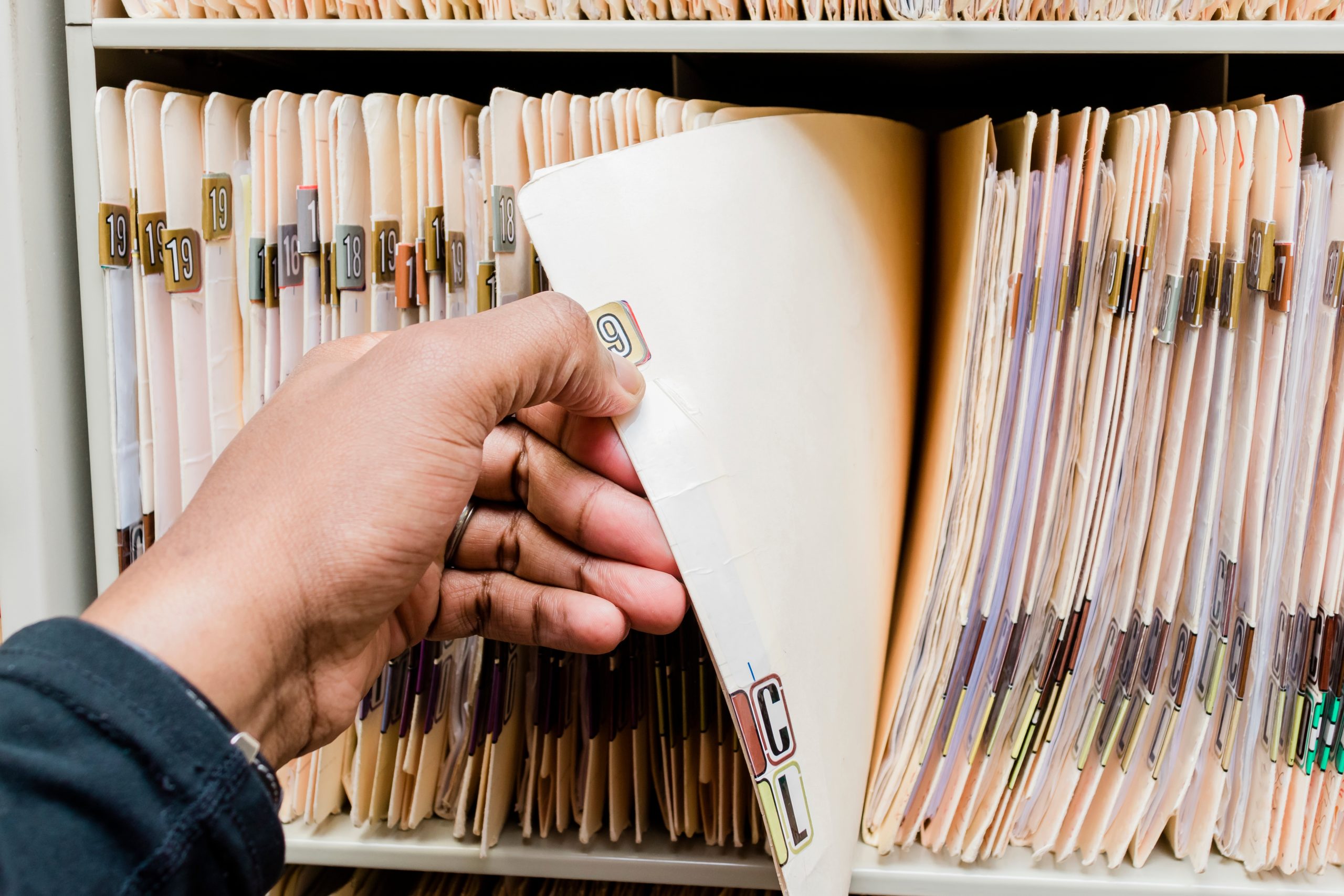 medical charts and records african american man sorting